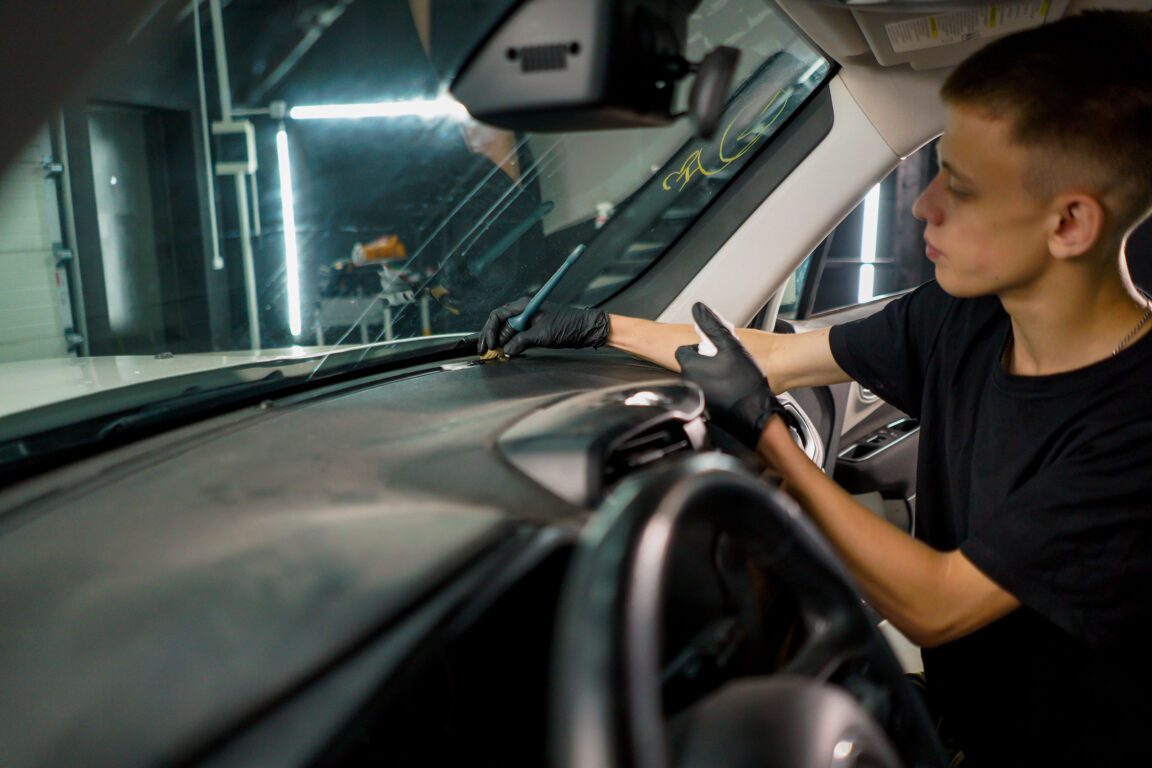 Worker installing a windshield